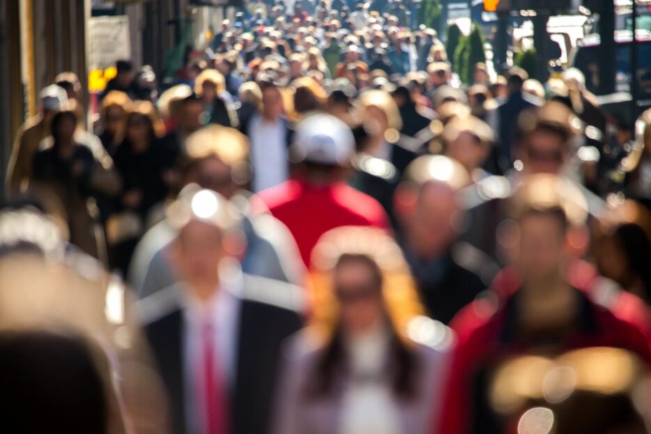 A lot of people walking on a footpath